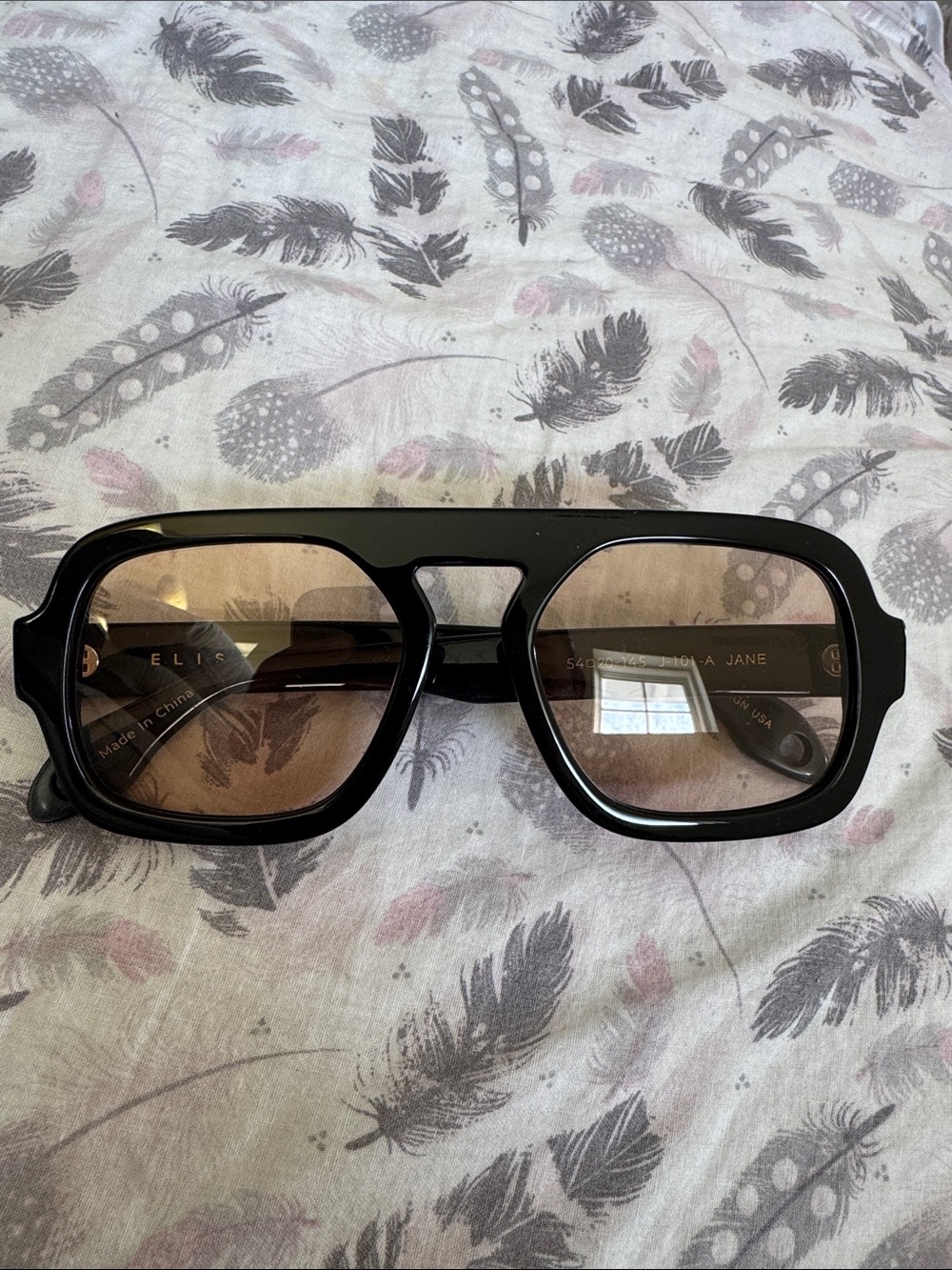 Black Frame Sunglasses with Brown Lenses by Elie